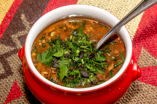 Stewed Cranberry Beans Or Borlotti In Tomato Sauce With Herbs Close-up In A Bowl On The Table. Horizontal Top View From Above