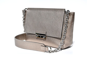 Genuine leather crossbody bag close up in gold color. Leather and metal combination.