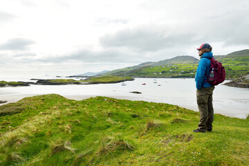 Male tourist admiring the Abbey Island, the idyllic patch of land in Derrynane Historic Park,...