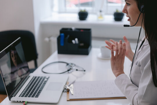 Physician consulting clients online 