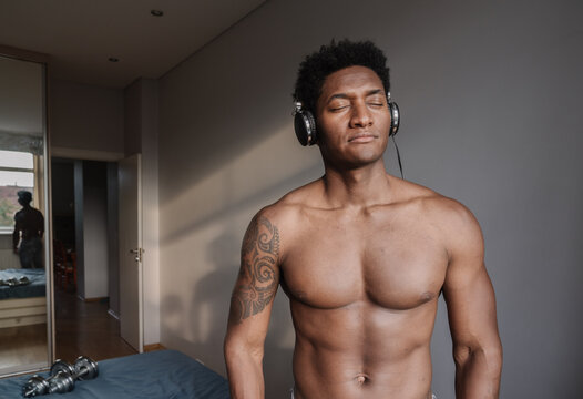 Athletic Man With Headphones At Home