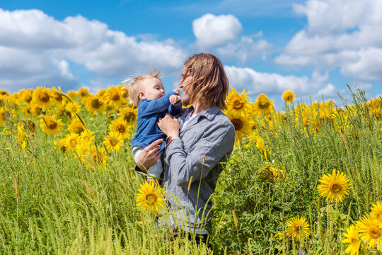 Father and son in sunflower field 