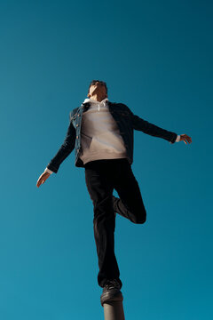 Free young man keeping balance