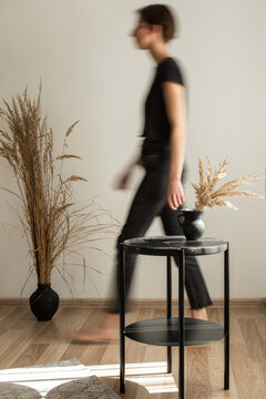 Interior photo of table with motion woman