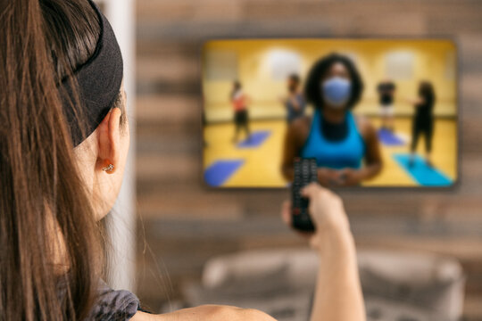 Home: Woman Uses Remote To Set Up Livestream Workout Class