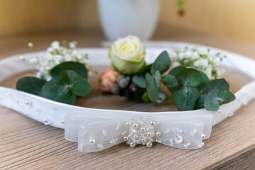 Bride's belt and wedding boutonnieres lie on the table