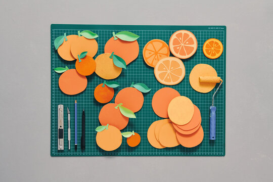 Paper cut out orange fruits and leaves craft.