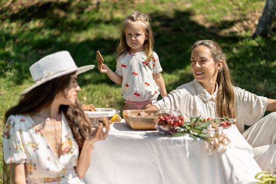 Family picnic on nature with berries and sweets