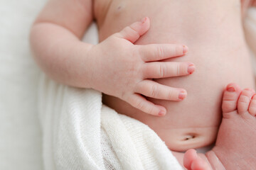 Baby fingers on his belly