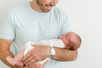 Dad in blue shirt smiles at his son