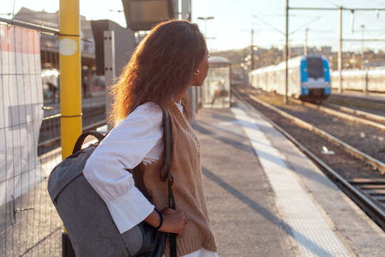 public transport, woman on railway station waiting for train, commute 