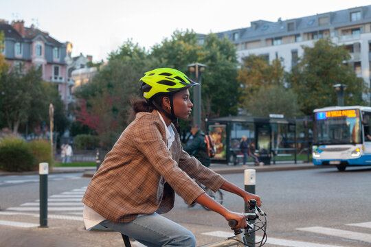 young black woman riding a bike in the city, bicycle commute