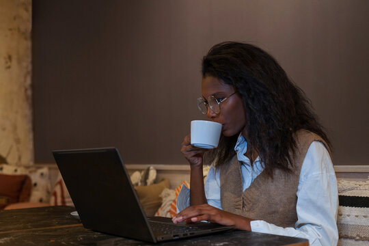 freelancer, business woman working on computer in cafe, drinks coffee