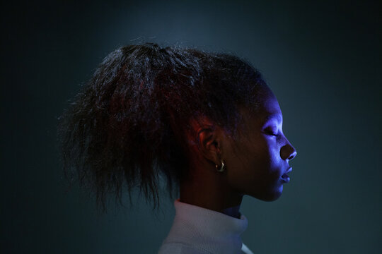 calm black woman with closed eyes, female face in profile, dark