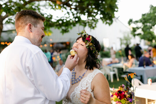 Groom Feeding Cake to Bride at Wedding