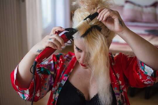 Curvy woman hairstyling at home