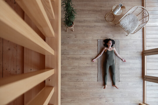 Brunette resting on floor during meditation session