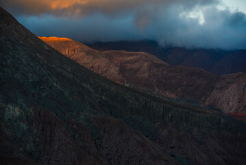 A sliver of alpenglow in the barren mountains above the winding Cuesta de Lipán road, near...