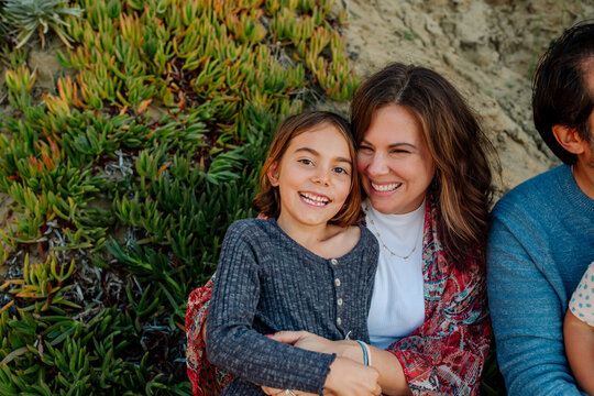 Beuatiful mother and daughter on sand dune