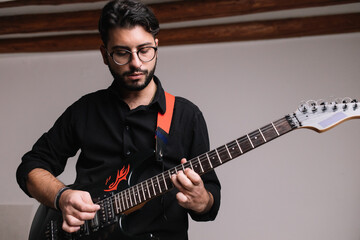 Rock Artist Playing Electric Guitar In Studio