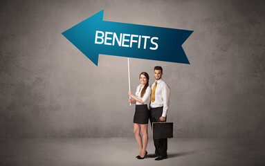 Young business person in casual holding road sign