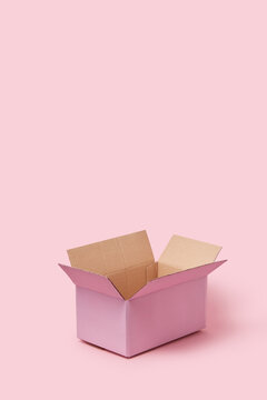 Cardboard box standing opened over pink background