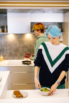 Couple making toasts with fresh avocado for breakfast 