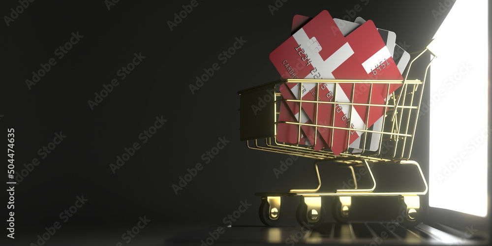 Poster bank card mockups with flags of denmark in a small shopping cart on the laptop. 3d rendering