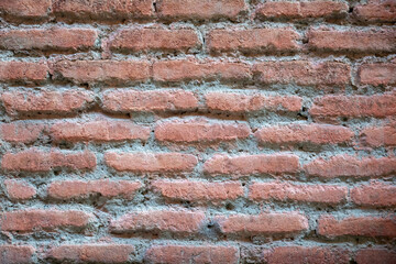 Background wall of red bricks. Wallpaper, texture of shabby bricks.