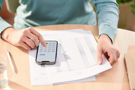 Person counting expenses and reading documents