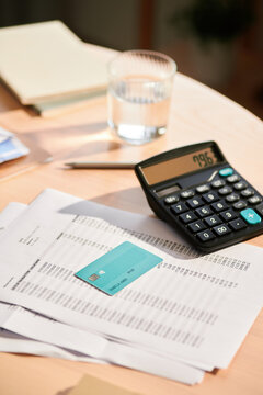 Credit card and paper bills on table