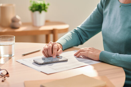 Woman managing personal budget and using calculator