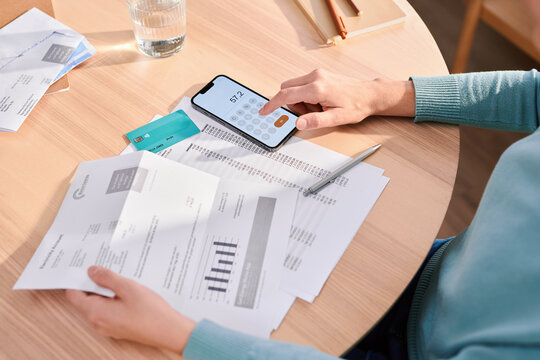 Crop woman paying bills and managing finances