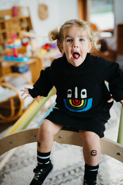 A kid sitting in her playroom