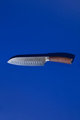 Chef's Knife on a blue background. The concept of minimalism
