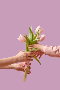 Child giving mother bouquet of spring tulips