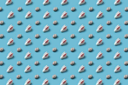 Seamless pattern of white rabbit figures and quail eggs