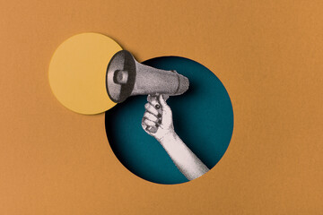 Hand holding a bullhorn