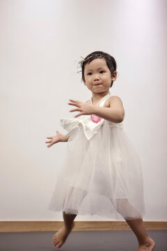 Closeup Asian little girl dancing at home

