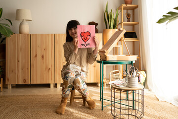 Girl showing artwork for mothers day