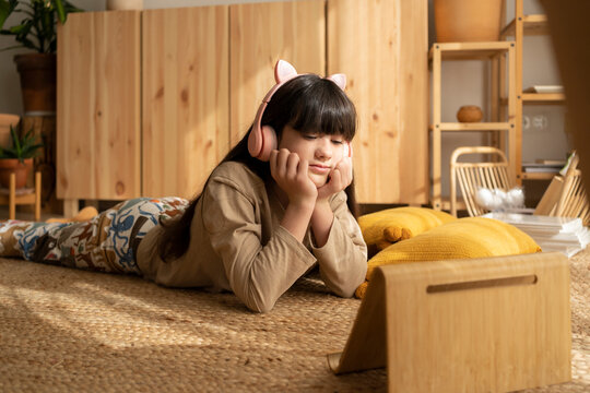 Cool girl looking at her tablet relaxing at home
