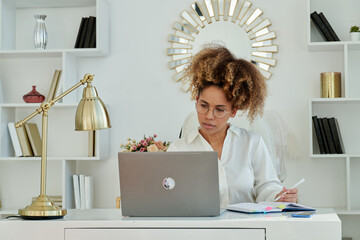 Successful Businesswoman Sitting At Laptop And Smiling