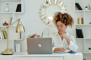 Girl Sitting At Laptop And Smiling In Modern Office. 