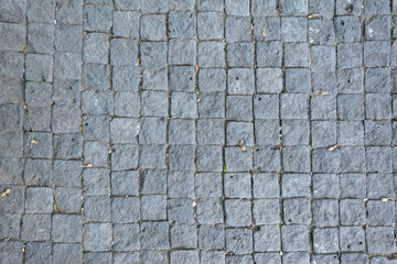 Background road from blocks. Wallpaper road large stones.