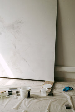 Plastic bucket with decorative putty near the drywall board