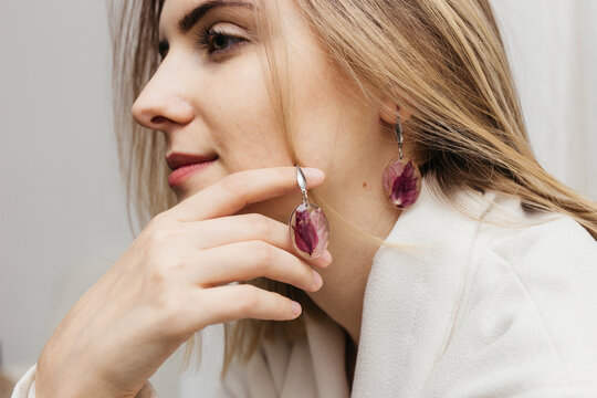 woman wearing floral epoxy earrings  