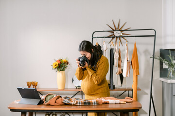 Pregnant taking photo of fashion design clothes