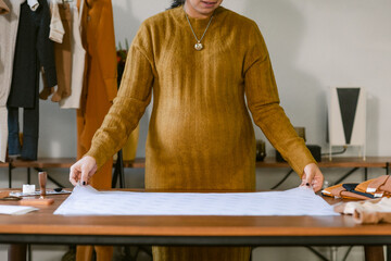 Pregnant businesswoman preparing package