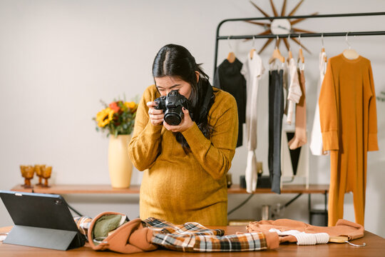 Pregnant taking pics to children clothes at work