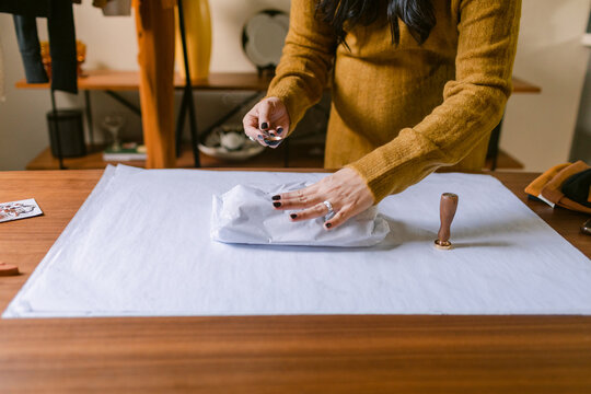 Crop woman retailer packing clothing orders 